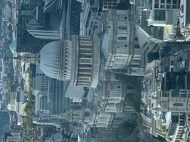 The dome of St Paul's Cathedral seen from above, low among the office buildings around it.