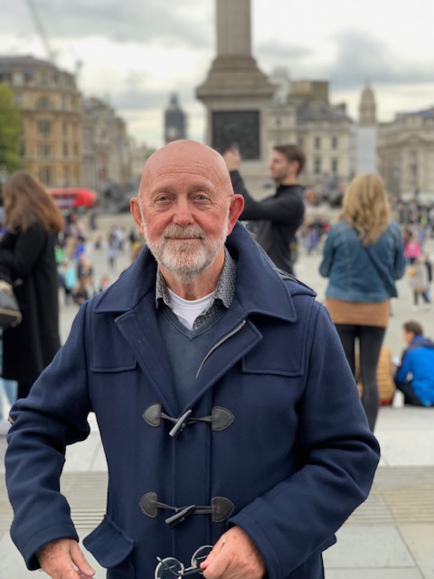 Henk on Trafalgar Square, with the column and passers-by behind him.