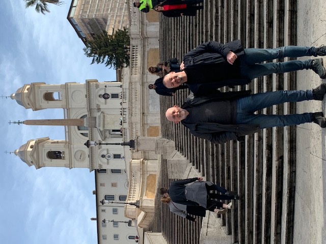 At the foot of the Spanish Steps, with the church of Trinità dei Monti and its two towers behind.