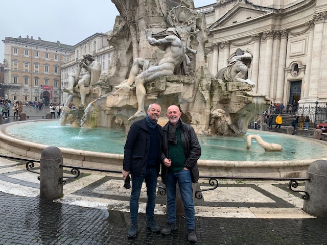 At the Fontana dei Quattro Fiumi on Piazza Navona, under a grey sky.