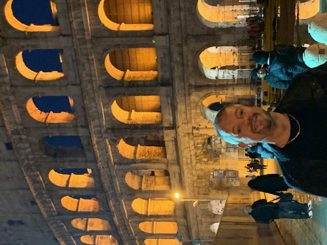 In the evening at the warmly lit Colosseum in Rome.